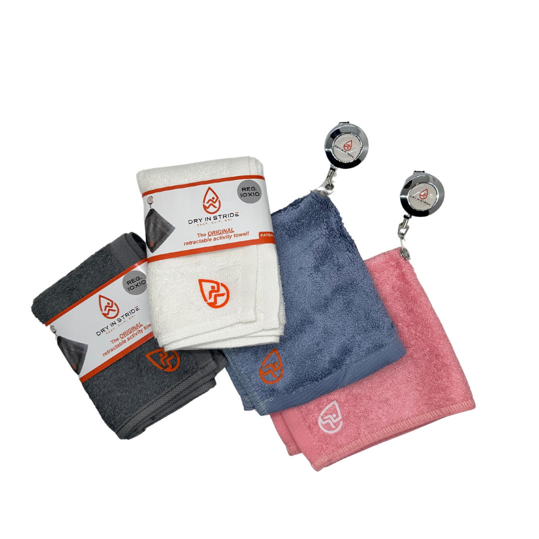 Set of four towels in gray, white, blue, and pink with a retractable tag on a white background.