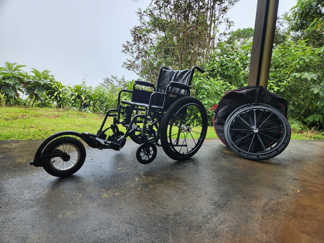All terrain \wheelchair with an additional front wheel. sitting in front of the rainforest. 