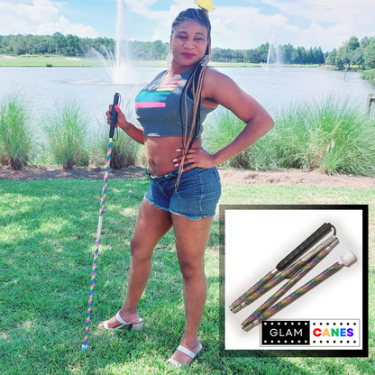 A woman poses confidently holding a rhinestone glam cane with a pride rainbow design