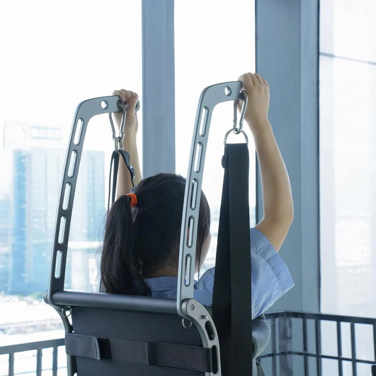 rear view of the standnwalk top part of the lift with a person standing in the lift and hands touching the top of the lift. 