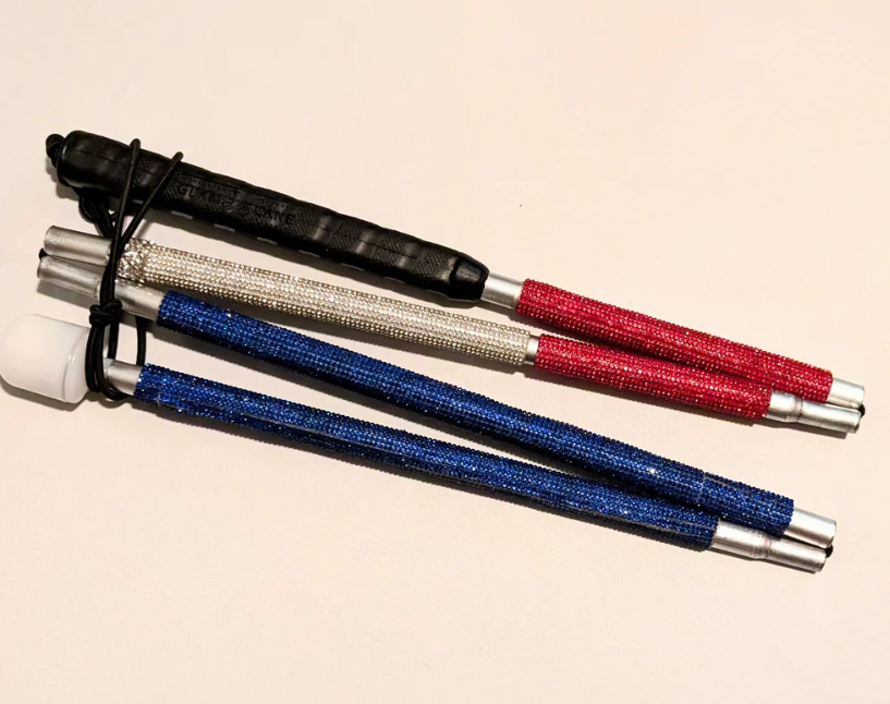 Cane folded. "The All-American" is a rhinestone cane that is ruby red at the top, silvery white in the middle, and blue at the end, mirroring the red, white & blue pattern representing the American flag. 